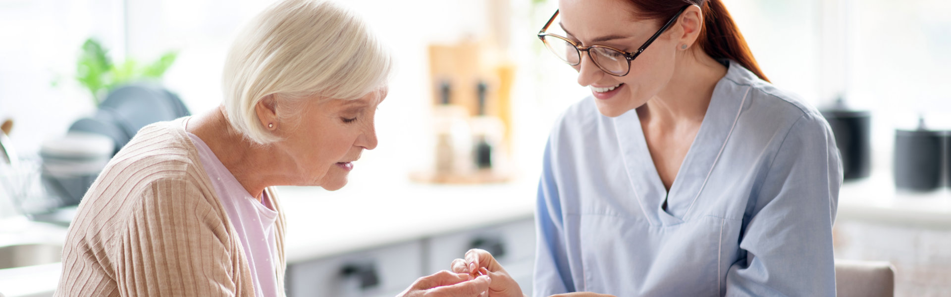 caregiver reminding senior woman with her medication