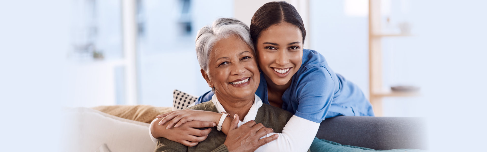 a caregiver hugging an elderly woman